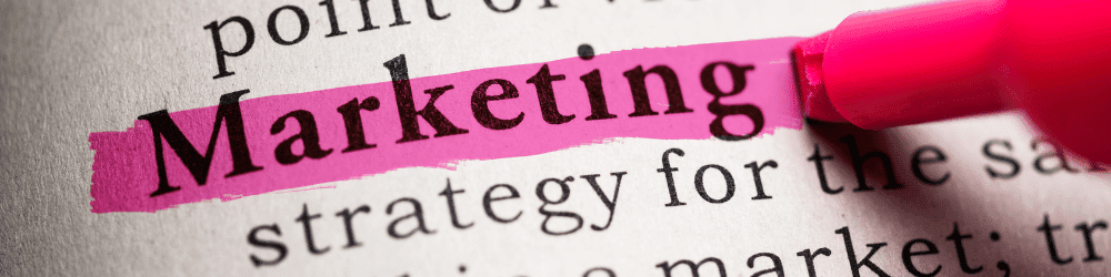 Dictionary page showing 'marketing' highlighted with highlighter pen